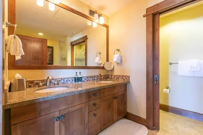 a bathroom with two sinks and a large mirror at Iron Horse Lodge South 401 by East West Hospitality in Truckee