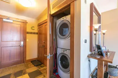 a laundry room with a washer and dryer at Iron Horse Lodge South 401 by East West Hospitality in Truckee