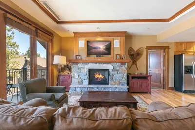 a living room with a couch and a fireplace at Iron Horse Lodge North 201 by East West Hospitality in Truckee