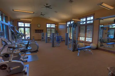 a gym with several treadmills and exercise bikes at Iron Horse Lodge North 201 by East West Hospitality in Truckee