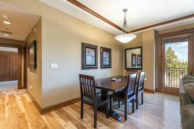 a dining room with a wooden table and chairs at Iron Horse Lodge North 201 by East West Hospitality in Truckee