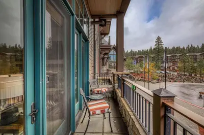 a balcony with chairs and a view of a playground at Iron Horse Lodge North 103 by East West Hospitality in Truckee