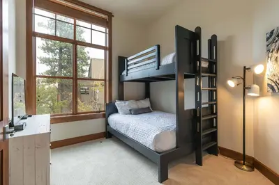 a bedroom with a bunk bed and a desk at Iron Horse Lodge North 103 by East West Hospitality in Truckee