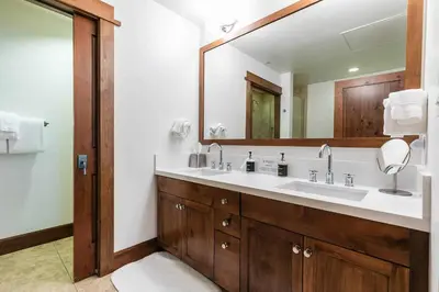 a bathroom with a sink and a large mirror at Iron Horse Lodge North 302 by East West Hospitality in Truckee