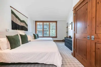 a bedroom with two beds and a large closet at Iron Horse Lodge North 302 by East West Hospitality in Truckee