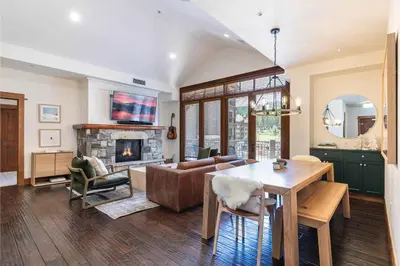a living room with a couch and a fireplace at Iron Horse Lodge North 302 by East West Hospitality in Truckee