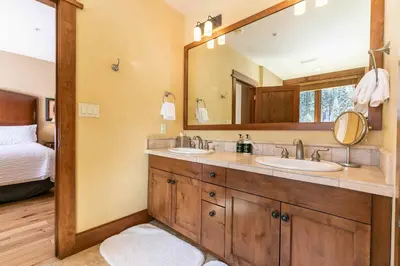 a bathroom with two sinks and a large mirror at Iron Horse Lodge South 312 by East West Hospitality in Truckee