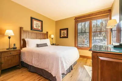 a bedroom with a bed and a window at Iron Horse Lodge South 312 by East West Hospitality in Truckee