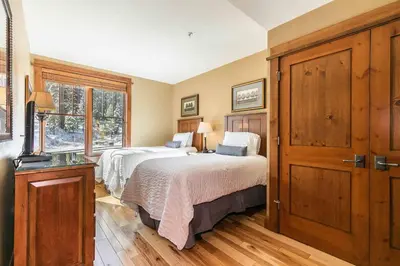 a bedroom with two beds and a window at Iron Horse Lodge South 312 by East West Hospitality in Truckee