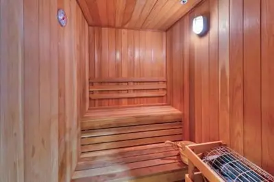 a sauna with wooden walls and a wooden floor at One Village Place 508 by East West Hospitality in Truckee