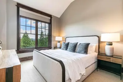 a bedroom with a large bed and a window at One Village Place 502 by East West Hospitality in Truckee
