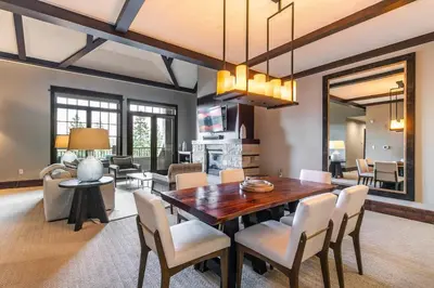 a dining room with a table and chairs at One Village Place 502 by East West Hospitality in Truckee