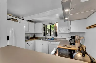 a kitchen with white cabinets and a sink at Bright 3BR Near Kings Beach and Northstar in Tahoe Vista