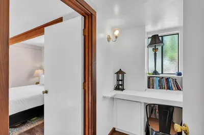 a bedroom with a bed and a window and a mirror at Bright 3BR Near Kings Beach and Northstar in Tahoe Vista