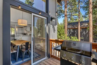 a tiny house with a grill and a table on a deck at Bright 3BR Near Kings Beach and Northstar in Tahoe Vista