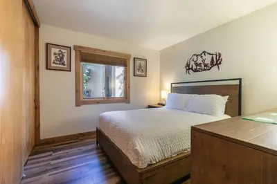 a bedroom with a bed and a window at Ski Trails 4119 by East West Hospitality in Truckee