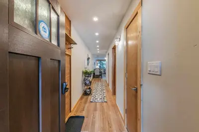 a hallway with a door and a hallway with a rug at Ski Trails 4115 by East West Hospitality in Truckee