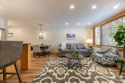 a living room with a couch and a table at Ski Trails 4115 by East West Hospitality in Truckee