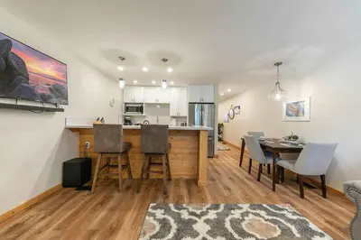 a kitchen and living room with a table and chairs at Ski Trails 4115 by East West Hospitality in Truckee