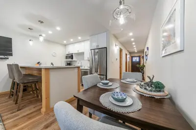 a kitchen and dining room with a table and chairs at Ski Trails 4115 by East West Hospitality in Truckee