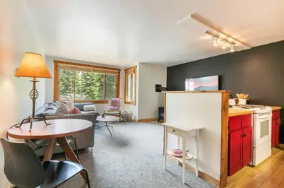 a kitchen and a living room with a table and a kitchen and a living room at Ski Trails 4099 by East West Hospitality in Truckee