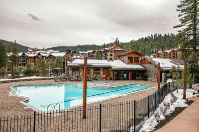 a large swimming pool in front of a resort at Ski Trails 4099 by East West Hospitality in Truckee
