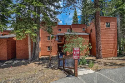 a home with a sign in front of it at Ski Trails 4099 by East West Hospitality in Truckee