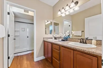 a bathroom with two sinks and a large mirror at 2BR Getaway Pool Gym Basketball Court & Theater Access in Reno