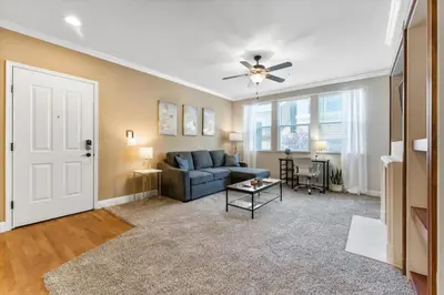 a living room with a couch and a ceiling fan at 2BR Getaway Pool Gym Basketball Court & Theater Access in Reno