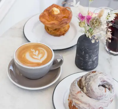 a cup of coffee and pastries on a table at 2BR Getaway Pool Gym Basketball Court & Theater Access in Reno