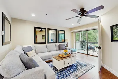 a living room with a couch and a ceiling fan at Knotty & Nice in Incline Village
