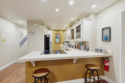 a kitchen with a counter and two stools at Knotty & Nice in Incline Village