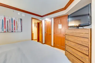 a bedroom with a bed and a flat screen tv at Pool and Hot Tub Access! Condo in Olympic Valley in Olympic Valley