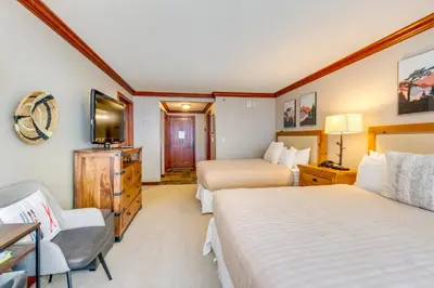 a hotel room with two beds and a television at Ski-InandSki-Out and Resort Perks Olympic Valley Gem in Olympic Valley
