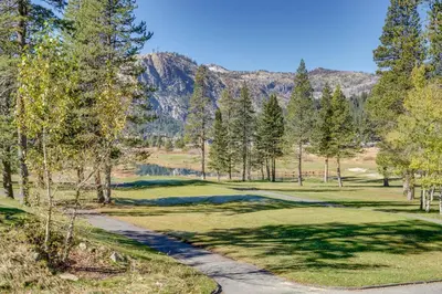 a view of a golf course with mountains in the background at Ski-InandSki-Out and Resort Perks Olympic Valley Gem in Olympic Valley