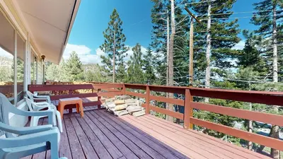 a deck with benches and a view of the woods at Lakeview Villas #24 condo in Mammoth Lakes