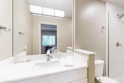 a white bathroom with a sink and a mirror at The Great Escape in Incline Village