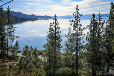 a view of a lake with trees in the foreground at The Great Escape in Incline Village