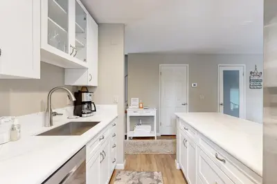 a kitchen with white counter tops and a sink at The Great Escape in Incline Village