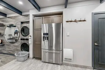a kitchen with a stainless steel refrigerator at Modern Mountain Retreat in Incline Village