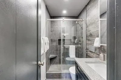 a bathroom with a shower and a toilet and a sink at Modern Mountain Retreat in Incline Village