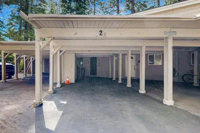 an empty garage with white columns and a building at Modern Mountain Retreat in Incline Village