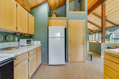 a kitchen with a white refrigerator and wooden cabinets at Close to Ski Slopes Tahoe Ski Chalet with Fireplace in Tahoe City