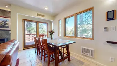 a dining room with a table and chairs and a couch at Lakeview Villas #26 condo in Mammoth Lakes