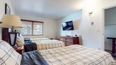 a hotel room with two beds and a flat screen tv at Lakeview Villas #26 condo in Mammoth Lakes