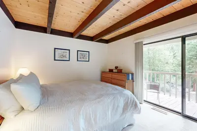 a bedroom with a bed and a large window at Kingswood Village #167 in Kings Beach