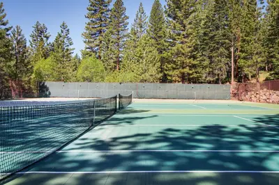 a tennis court with trees in the background at Kingswood Village #167 in Kings Beach