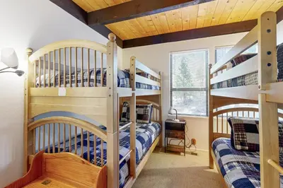 two bunk beds in a boys room with a vaulted ceiling at Kingswood Village #167 in Kings Beach
