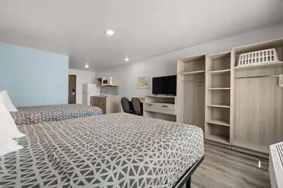 a hotel room with two beds and a television at WoodSpring Suites Ceres - Modesto in Ceres