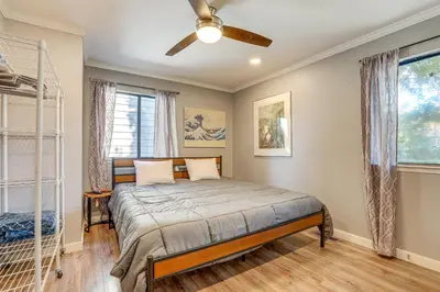 a bedroom with a bed with a fan and a window at Downtown Fair Oaks Home about 15 Mi to Sacramento! in Fair Oaks